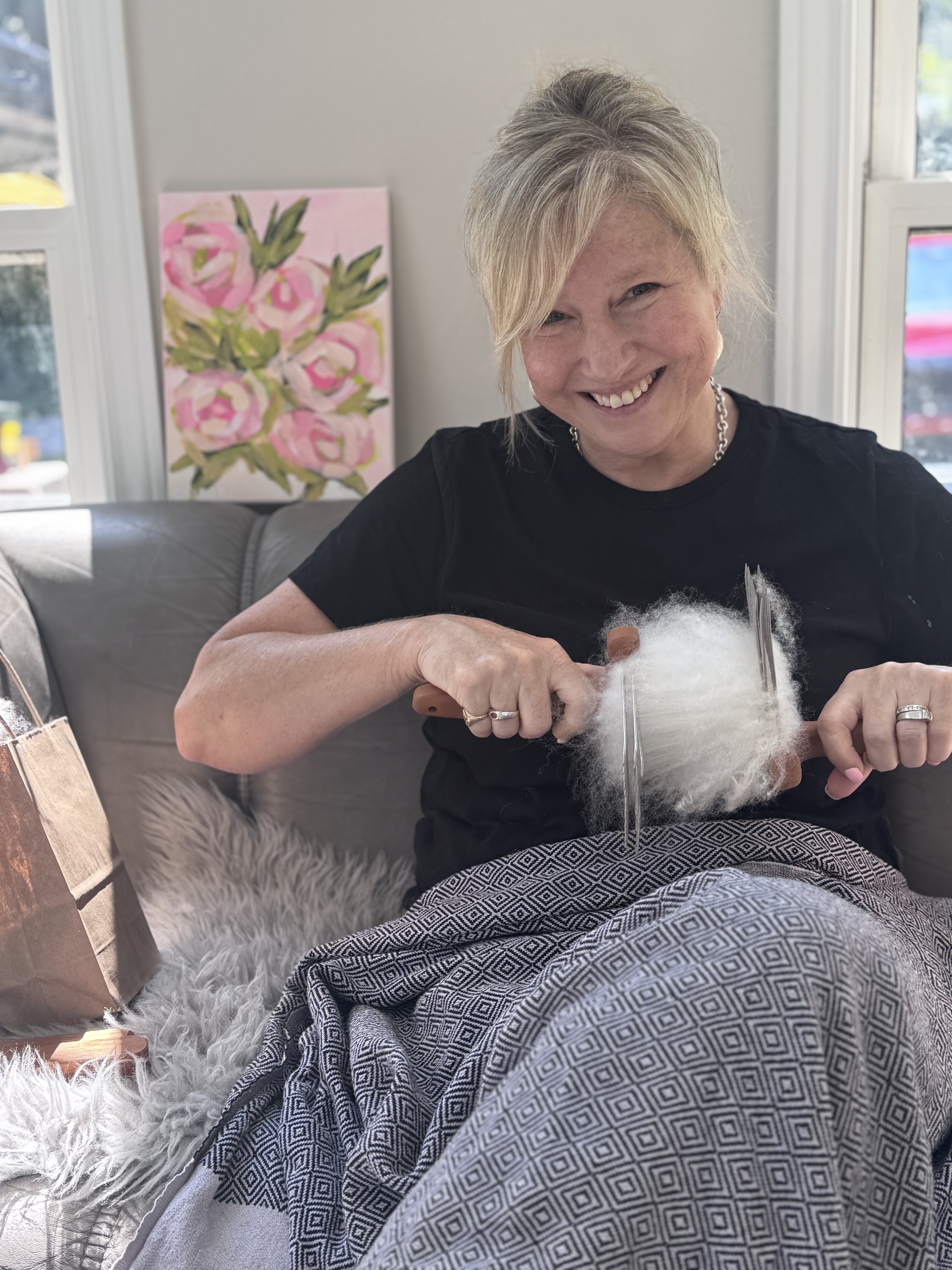 Lisa Paddle carding wool, gently preparing the fibres for her next felted creation.